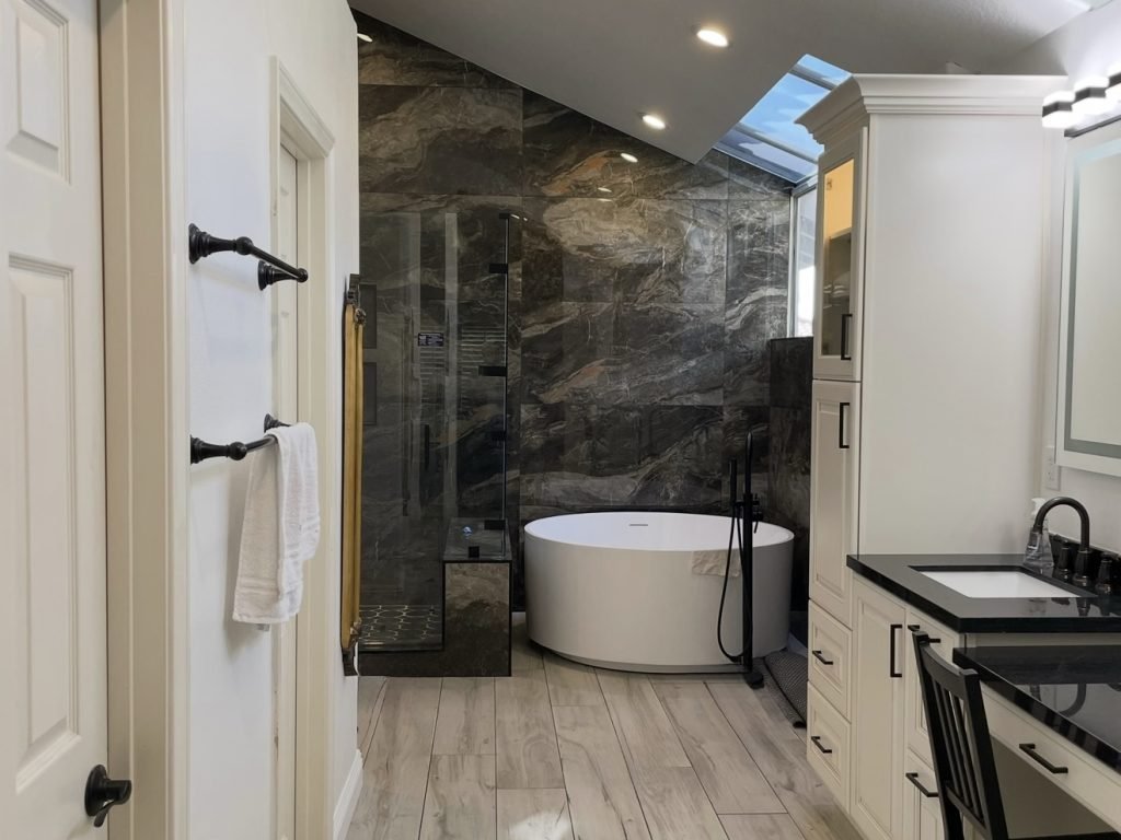 Bathroom renovation featuring marble flooring by Alfa Construction & Remodeling